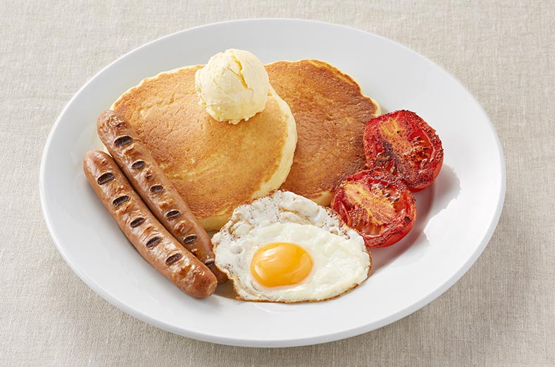 Pancakes, eggs, tomatoes, sausages